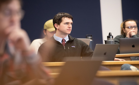 A student sits in a classroom listening to instruction