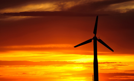 A wind turbine in front of a Wyoming sunset