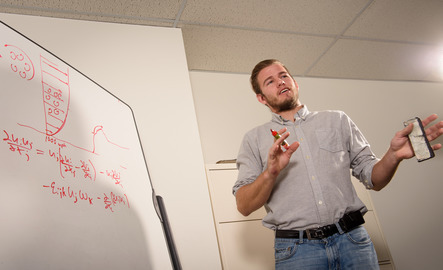 Student explains a problem on the white board