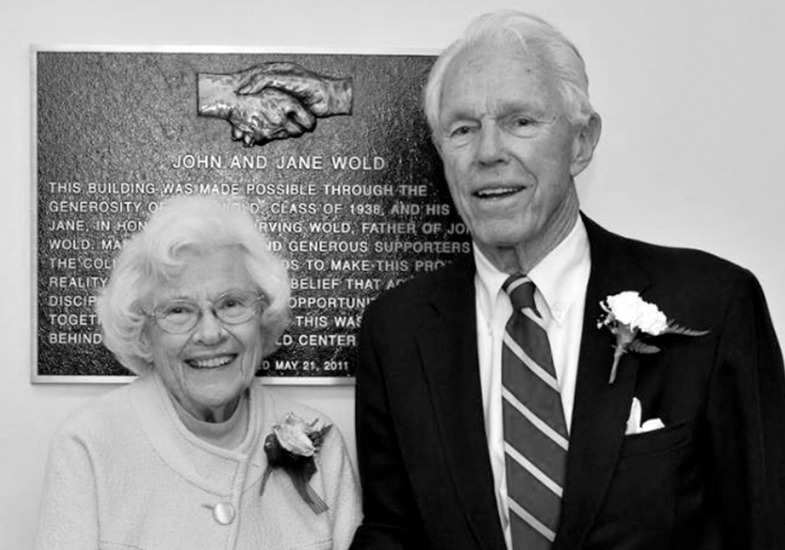 archive image of man and woman in front of a plaque