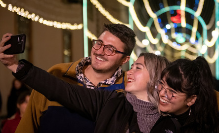 UW study abroad student smile for a picture on a night out during their program.