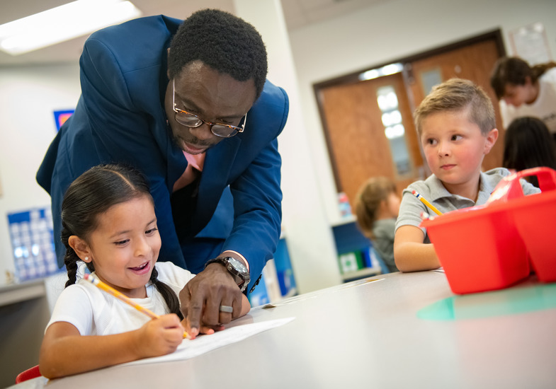 Photo of College of Education student working on an assignment with an elementary student.