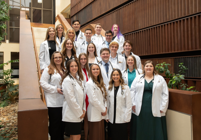 20 WWAMI Medical students standing on staircase.