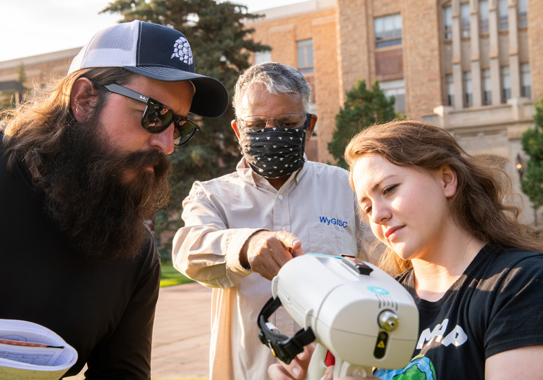 A professor works with two students