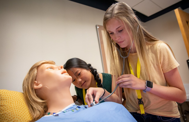 A student checks out a patient simulator mannequin.
